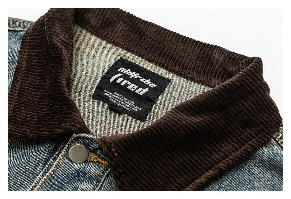 Close-up of a blue denim jacket’s brown corduroy collar, metal button and sewn neck label.