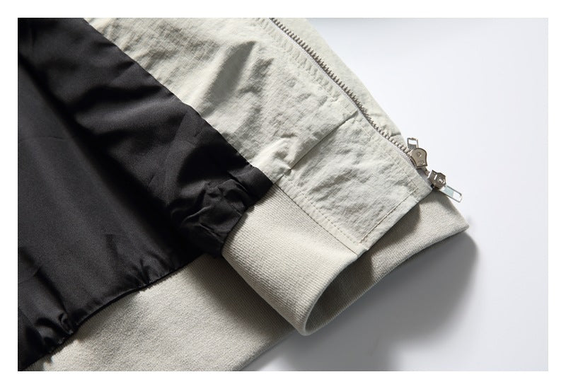 Close-up of a pale gray zippered sleeve cuff with a ribbed band and black lining.