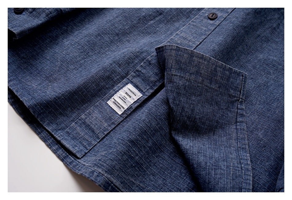 Close-up of the blue grid-patterned shirt interior, showing a sewn-in label and button placket.
