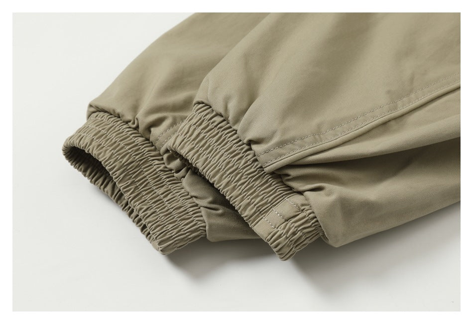 Close-up of gathered elastic cuffs on a beige garment.
