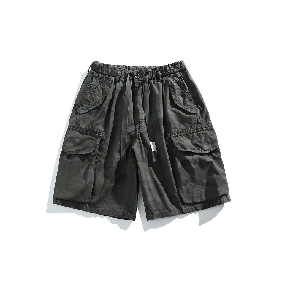Dark gray camouflage cargo shorts with drawstring waist and large flap side pockets, front view