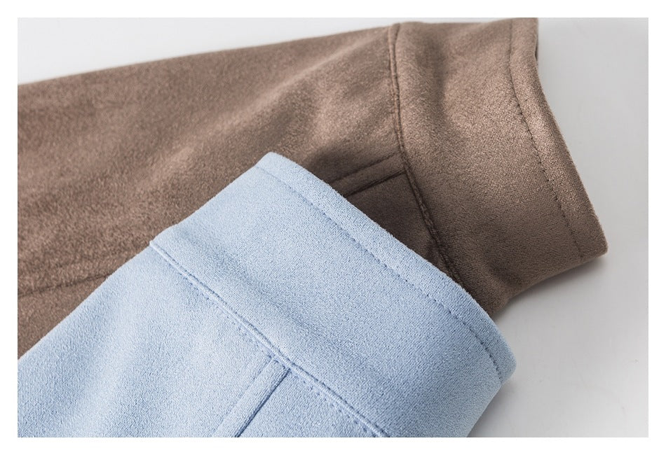 Close-up of brown and light blue jacket sleeve cuffs, showing the fabric surface and stitched edges.