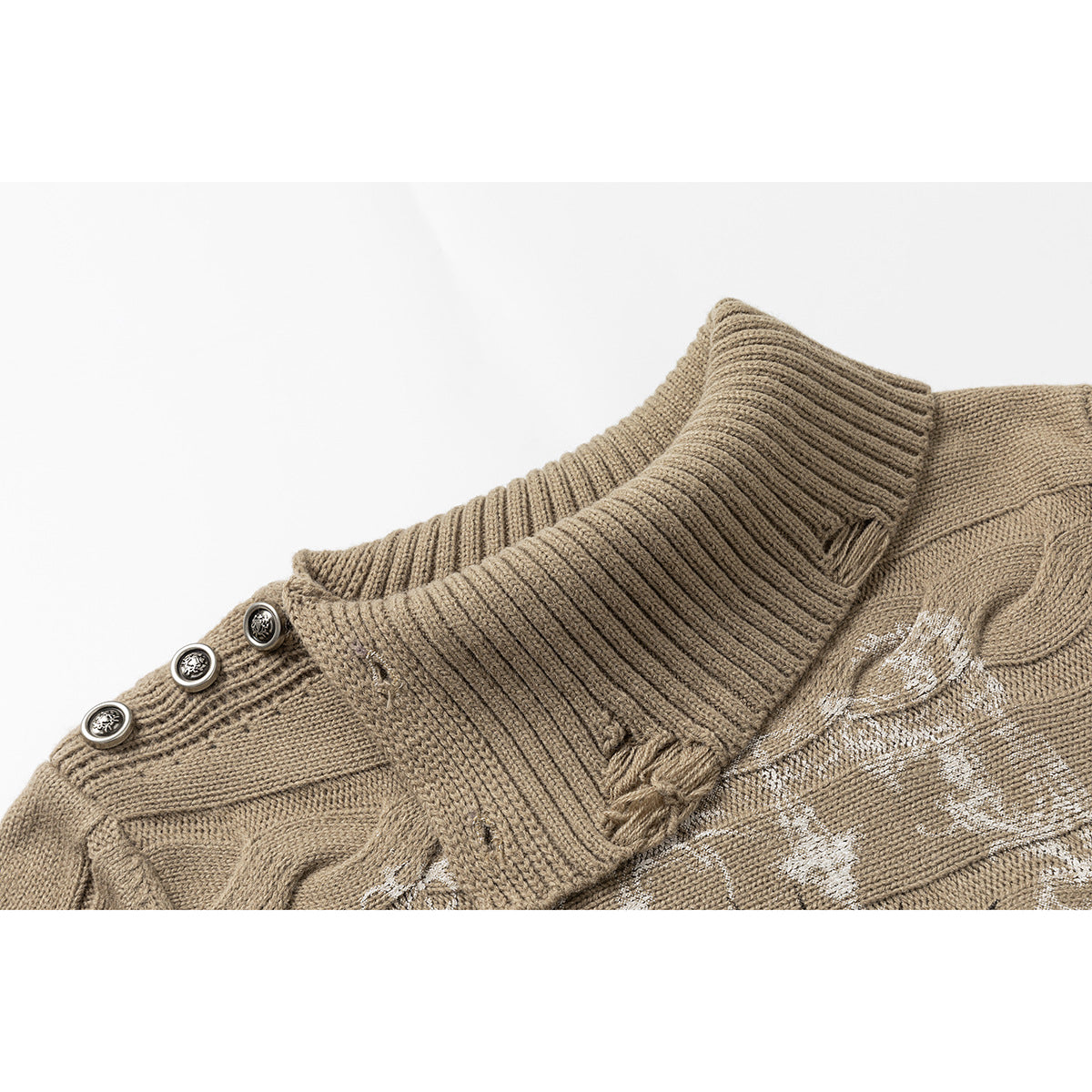 Close-up of a taupe cable-knit sweater collar with ribbed folds, three ornate shoulder buttons, and part of a white graphic.