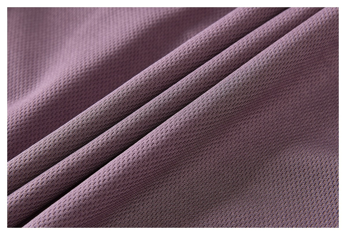 Close-up of mauve textured fabric arranged in soft folds.