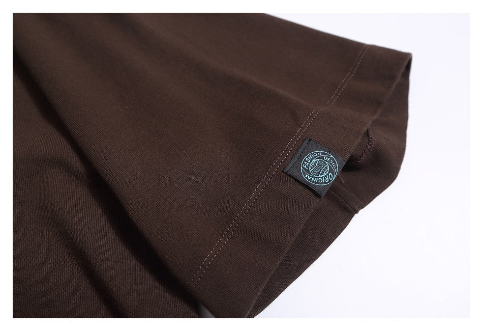 Close-up of a dark brown shirt sleeve hem with a small sewn label.