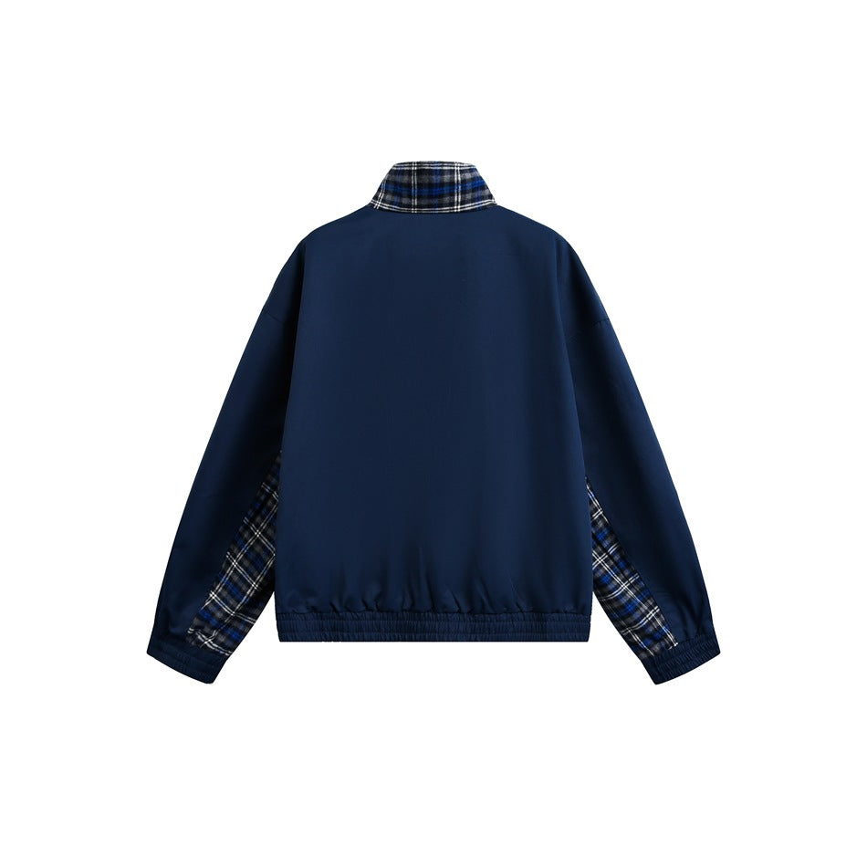 Back view of a navy jacket with a plaid collar and plaid sections along the sleeves.
