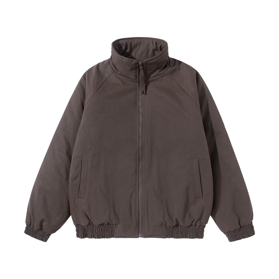 Brown stand-collar zip jacket with raglan sleeves, front pockets and elastic cuffs and hem, flat lay front view