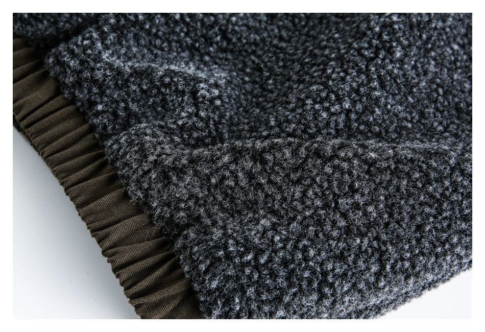 Close-up of dark charcoal looped fleece beside a brown ribbed fabric edge.