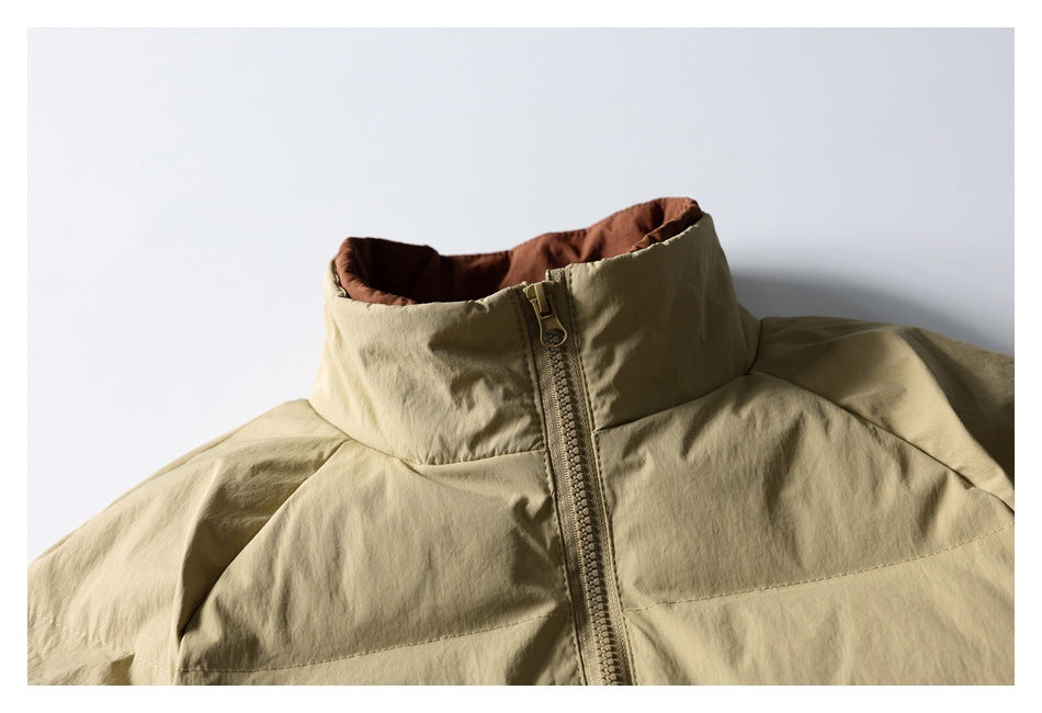 Close-up of a khaki jacket front with a tall rust-lined collar and central zipper.