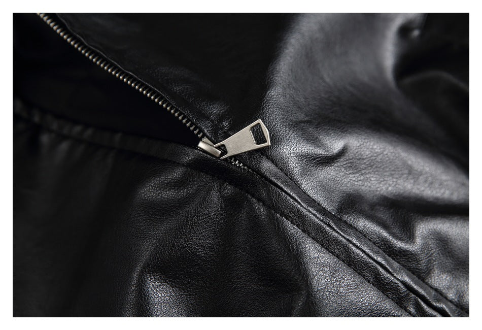Close-up of a silver zipper pull and zipper teeth on the black jacket.