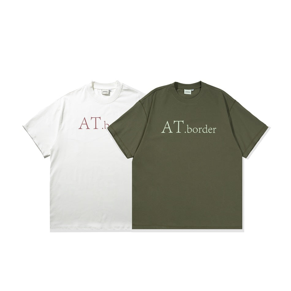 Two oversized crew-neck T-shirts shown flat: white with red lettering and olive-brown with pale lettering.