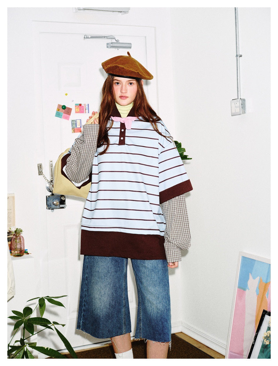 Model wearing the striped layered polo top with checked sleeves, denim shorts and a brown beret, front view