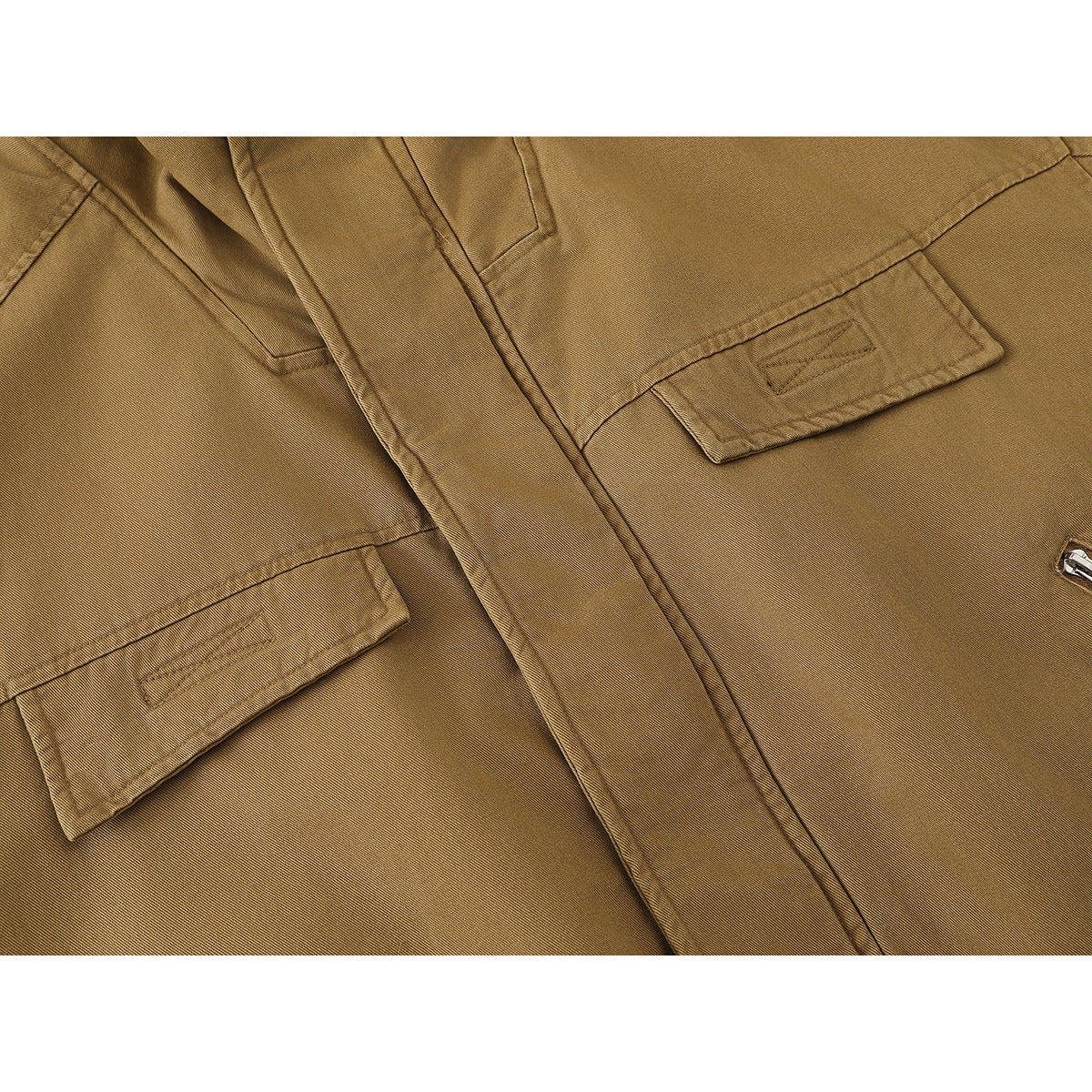 Close-up of a tan jacket front showing flap chest pockets, a covered closure and angled zip pockets.