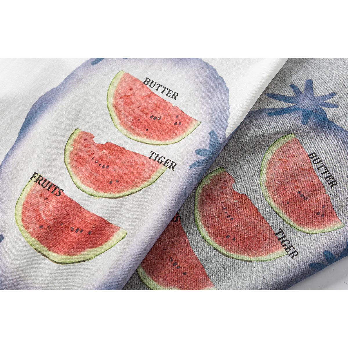 Close-up of watermelon and blue floral graphics with English words printed on white and gray T-shirt fabric.