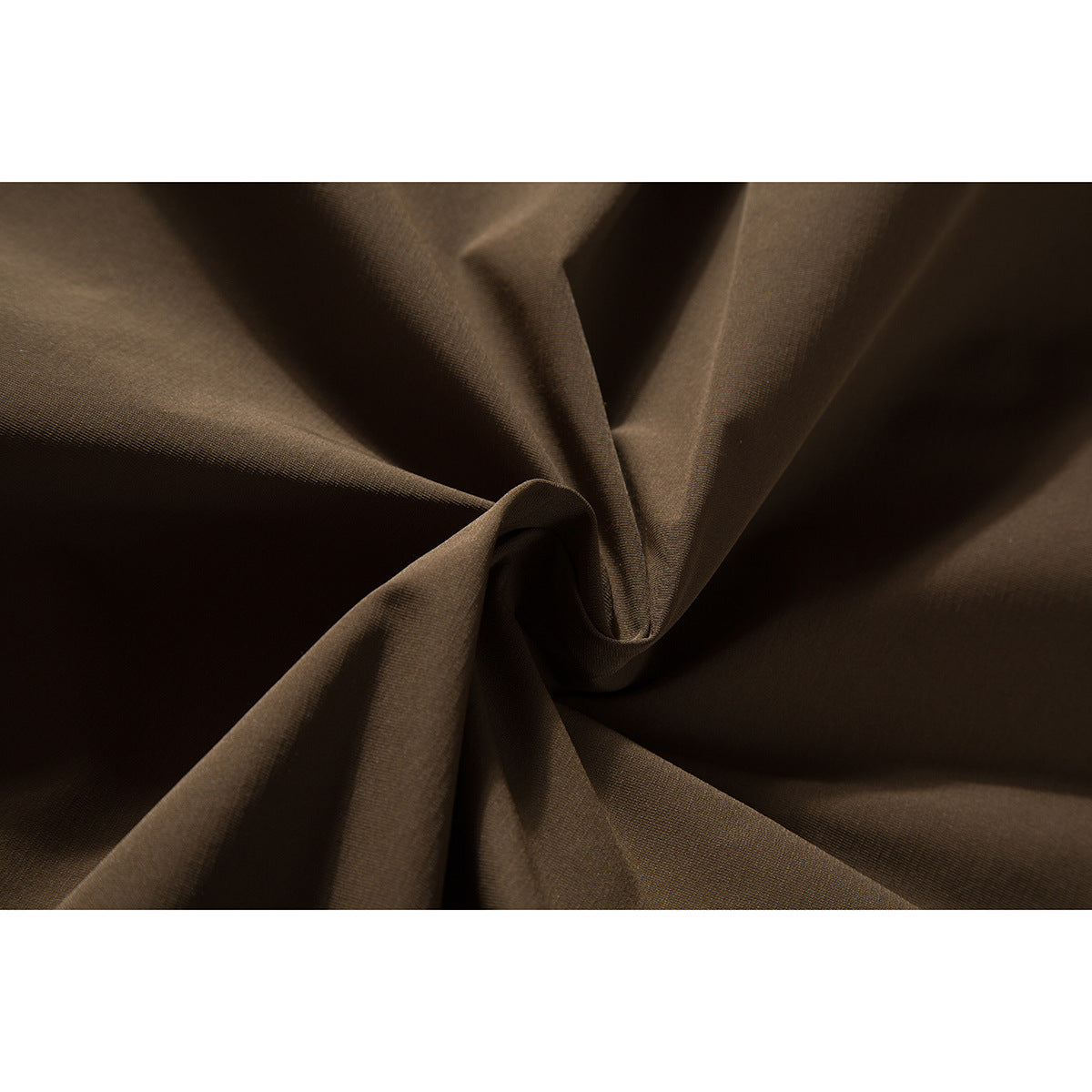 Close-up of brown jacket fabric gathered into soft folds.