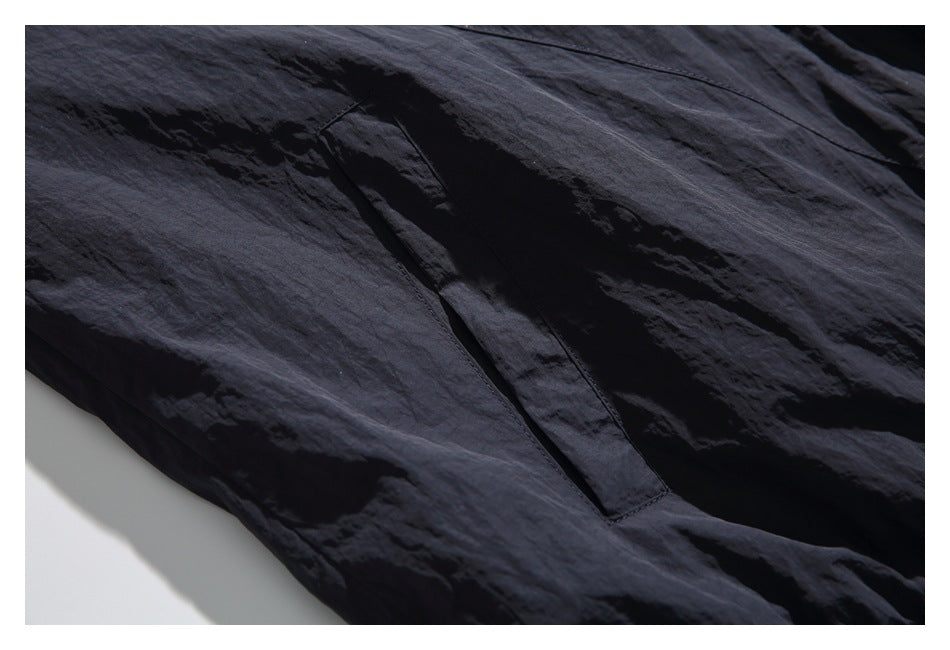 Close-up of a long, narrow pocket on dark navy fabric.