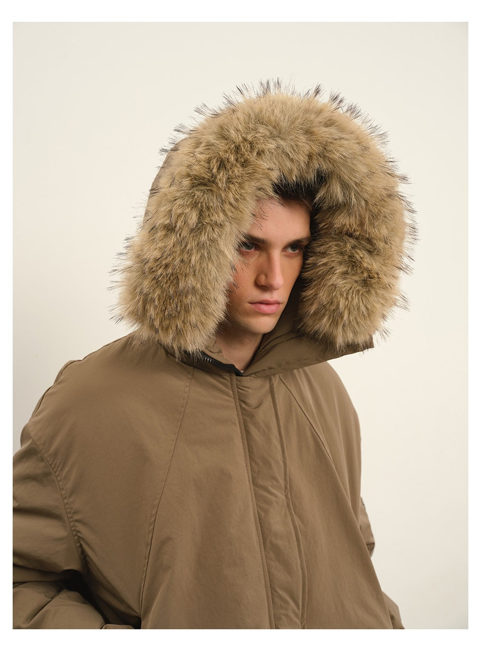 Model wearing a taupe hooded jacket with a large tan fur-trimmed hood.