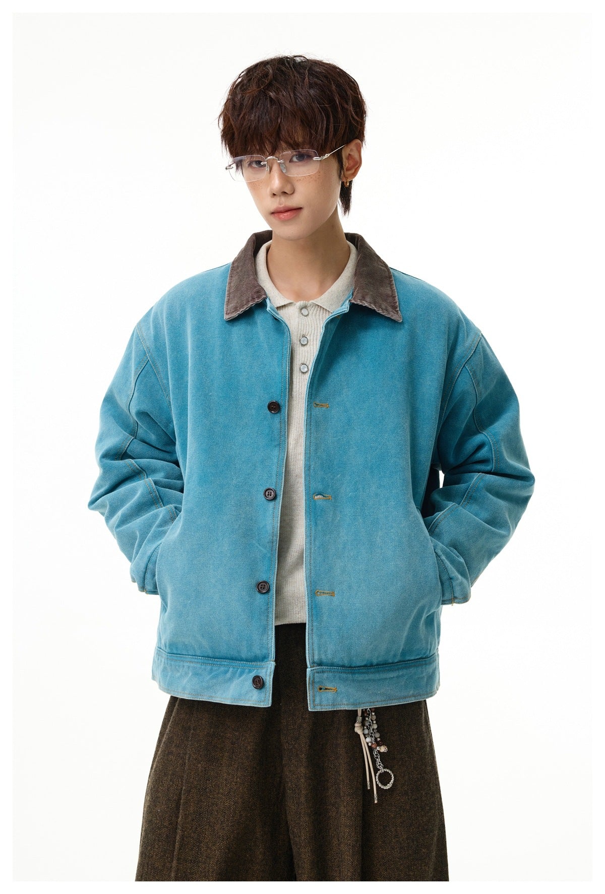 Model wearing a teal button-front jacket with a brown collar, shown from the front against a white background.
