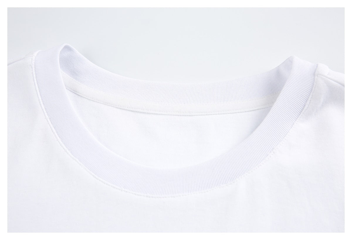 Close-up of the ribbed crew neckline and shoulder seam of a white T-shirt.