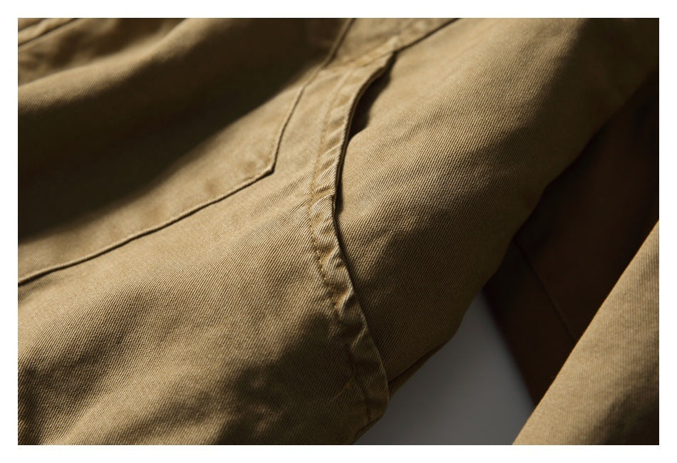 Close-up of tan jacket fabric and a curved stitched seam.