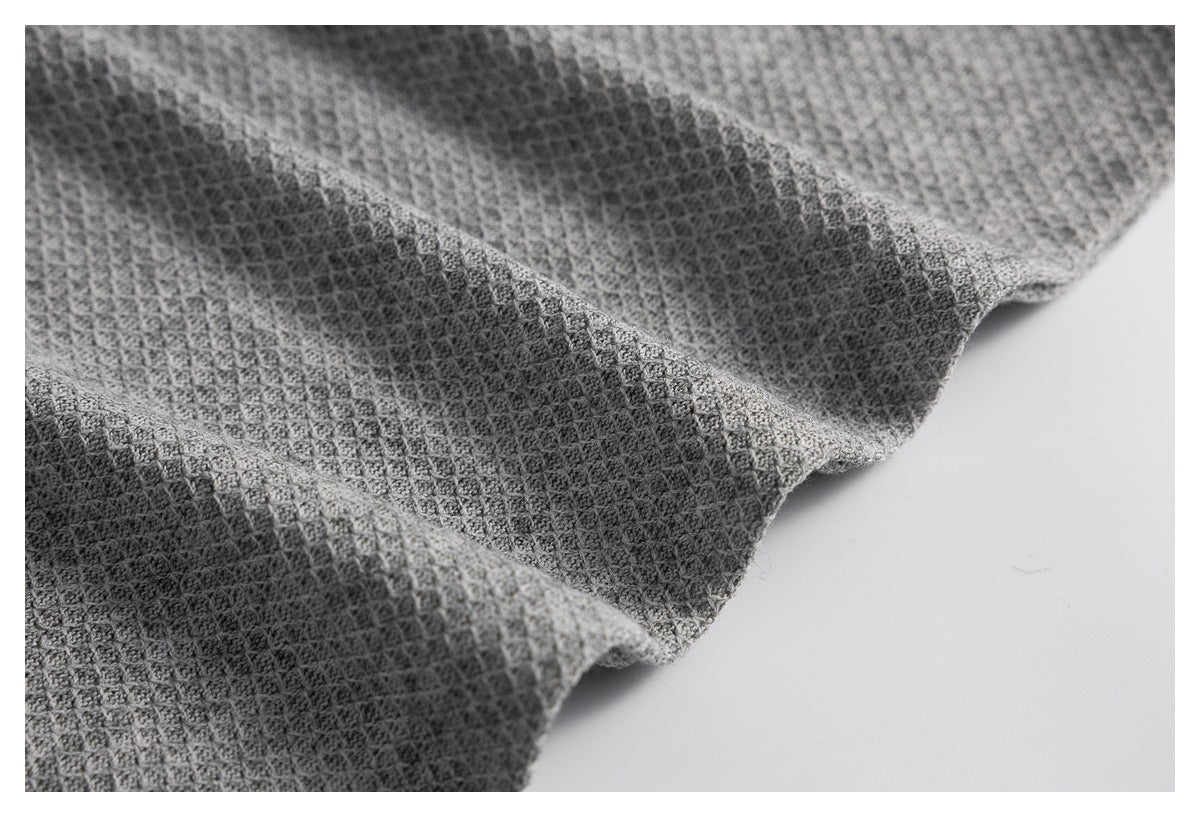 Close-up showing the gray top's raised textured fabric and draped edge.