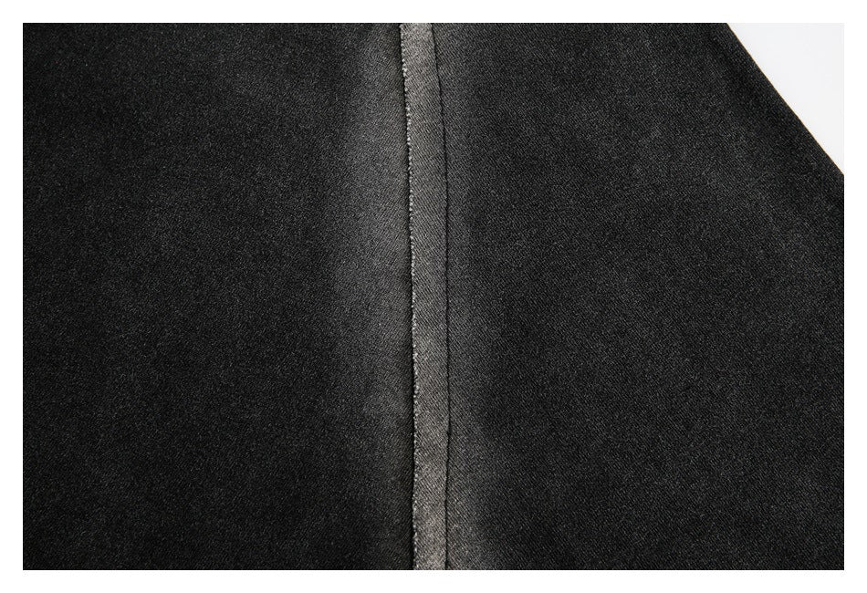 Close-up of black fabric with a vertical stitched seam.