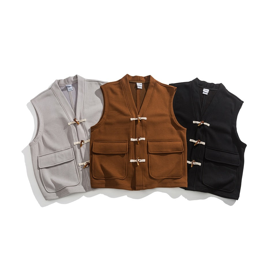 Three sleeveless vests arranged front-facing in taupe, rust brown, and black, with toggle closures and flap pockets.