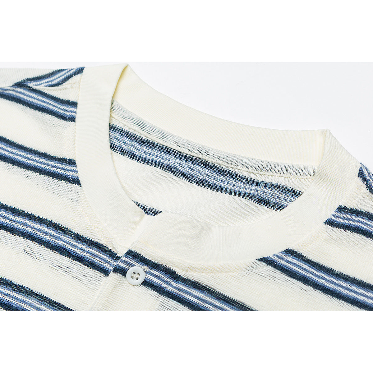 Close-up of an ivory crew neckline and button placket on a navy-and-white striped shirt.