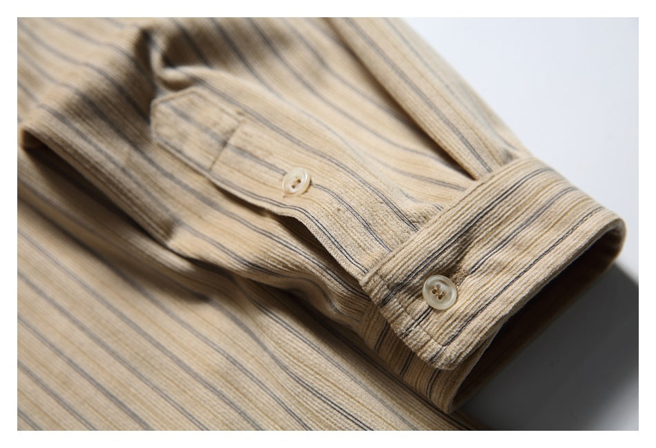 Close-up of the striped beige shirt's buttoned cuff and sleeve on a white background.