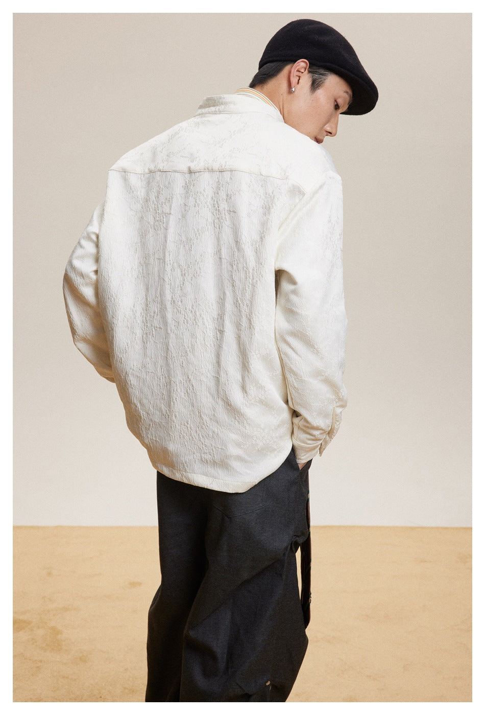 Model shown from behind wearing an ivory long-sleeve jacket with a subtle textured pattern.