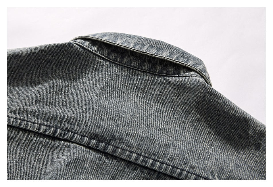 Close-up of the denim jacket's back collar and yoke stitching.
