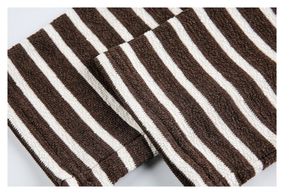Close-up of a ribbed edge on a brown-and-cream striped knit top.