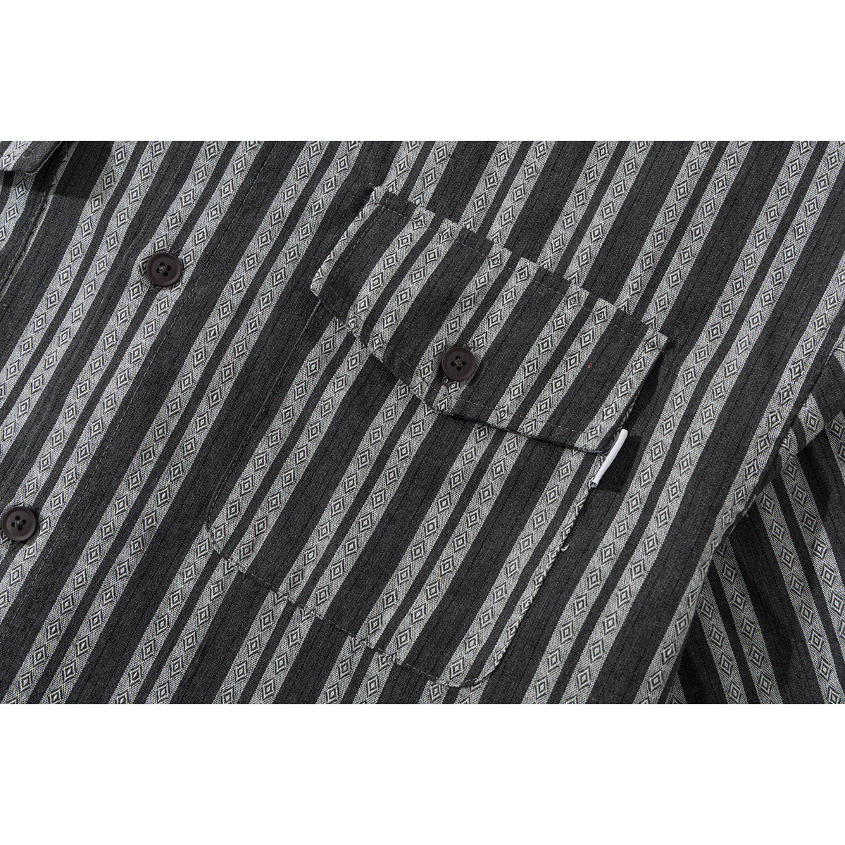 Close-up of a charcoal gray shirt showing its diamond-patterned stripes, button placket, and chest pocket.