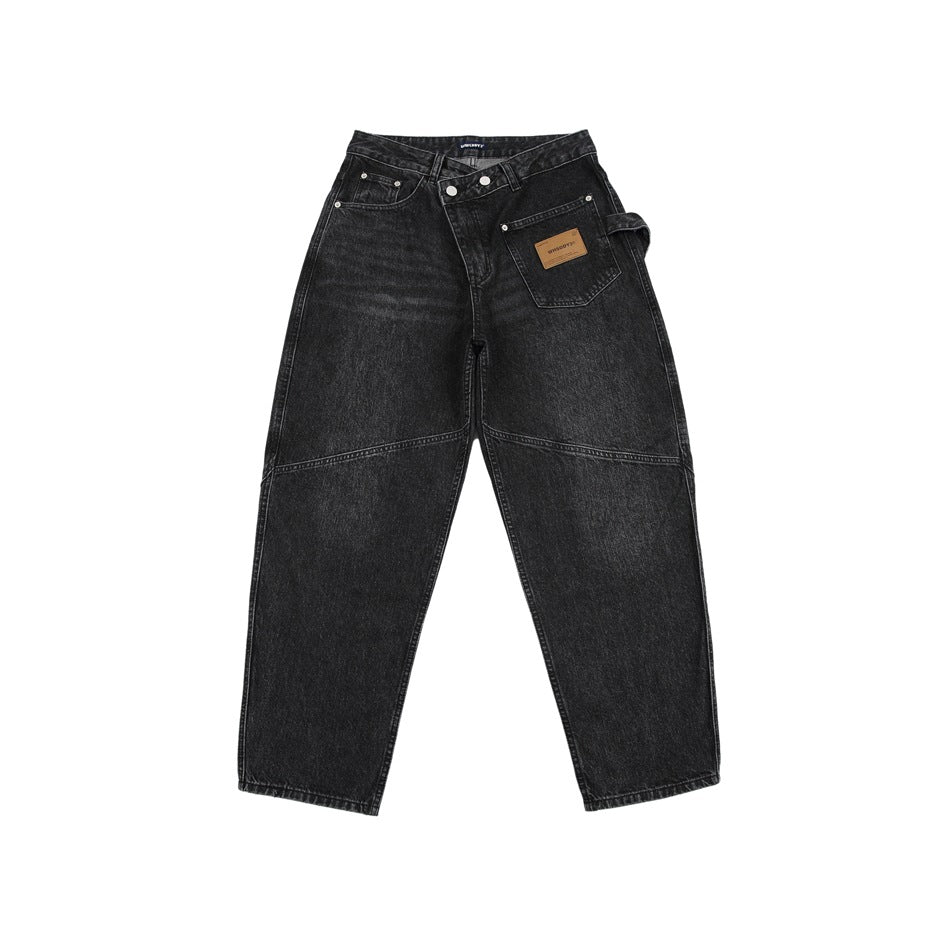 Black washed denim jeans, front flat view with asymmetric waistband, patch pocket and knee seams