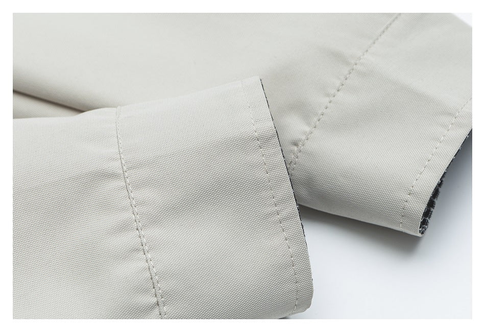 Close-up of a wide, stitched cuff in light beige fabric.