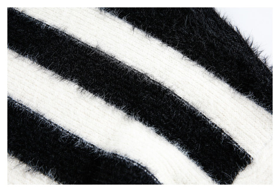 Extreme close-up of broad black and ivory stripes in a fuzzy knit fabric.