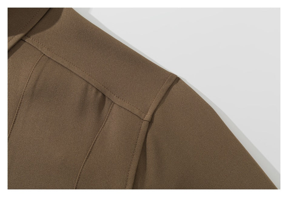 Close-up of the brown garment's shoulder seam and upper sleeve.
