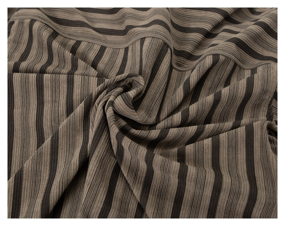 Close-up of taupe and dark brown striped fabric gathered into soft folds.