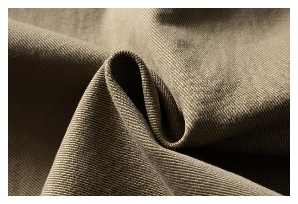 Close-up of tan-brown twill fabric folded to show its diagonal weave.
