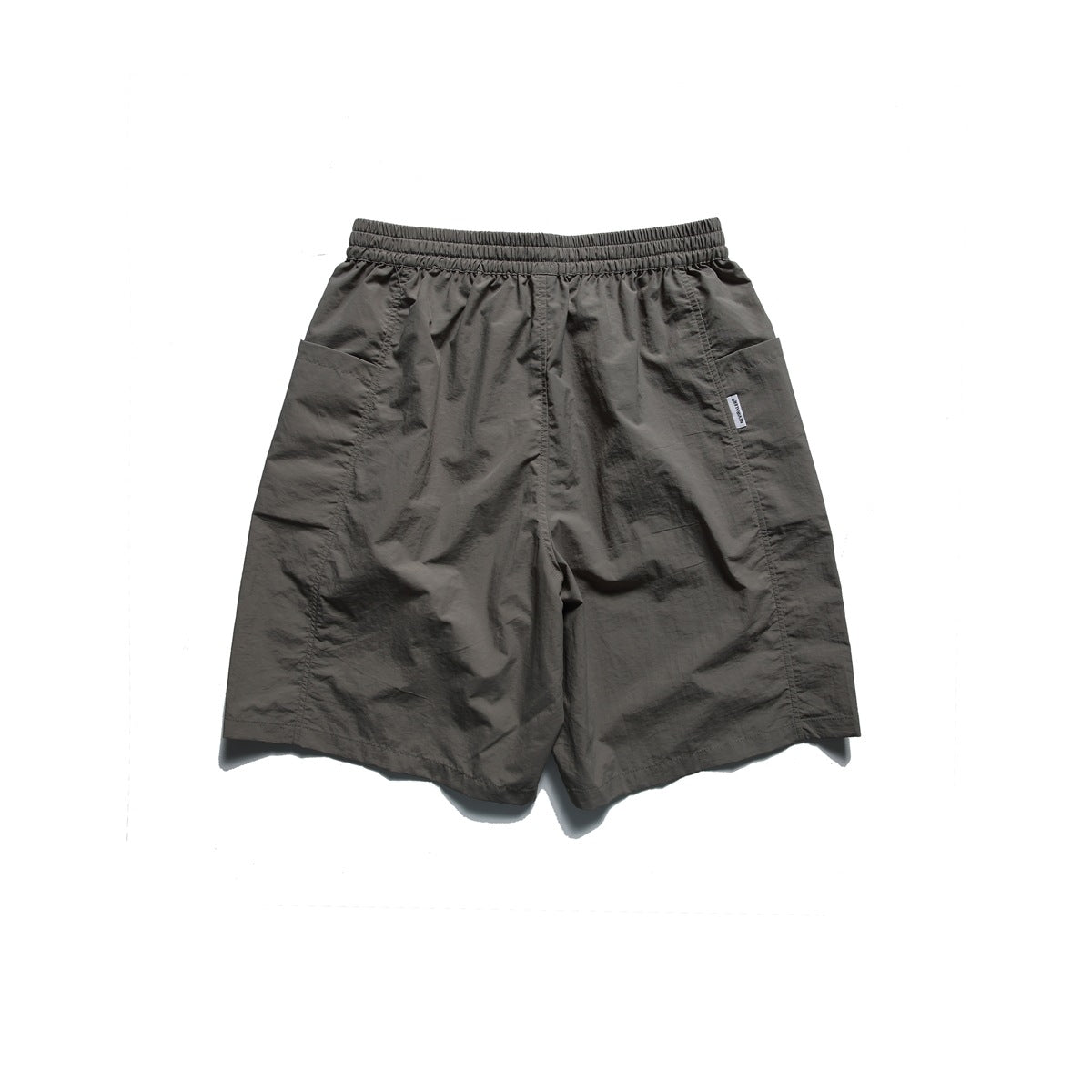 Back view of charcoal-gray shorts with an elastic waistband and large side pockets.