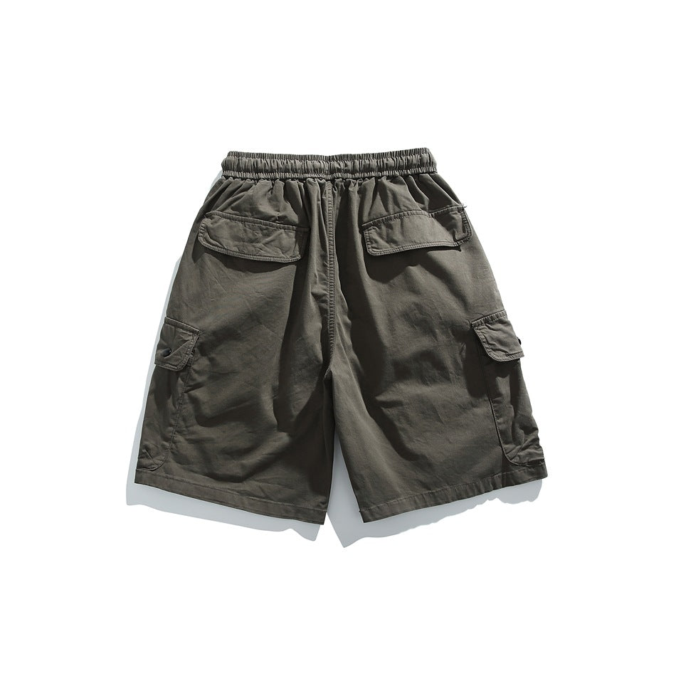 Back view of dark olive cargo shorts with an elastic waist, two rear flap pockets, and side cargo pockets.