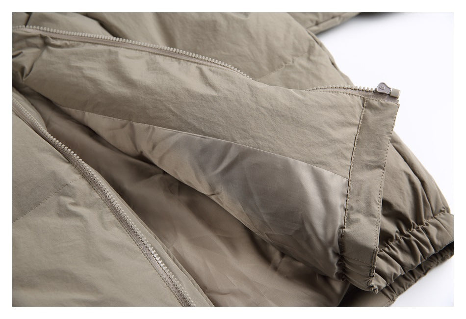 Close-up of a taupe jacket sleeve with a zipper and gathered elastic cuff.