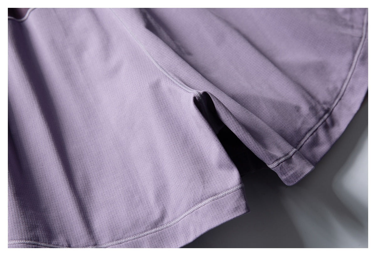 Close-up of a purple garment hem with a small side slit and visible stitching.