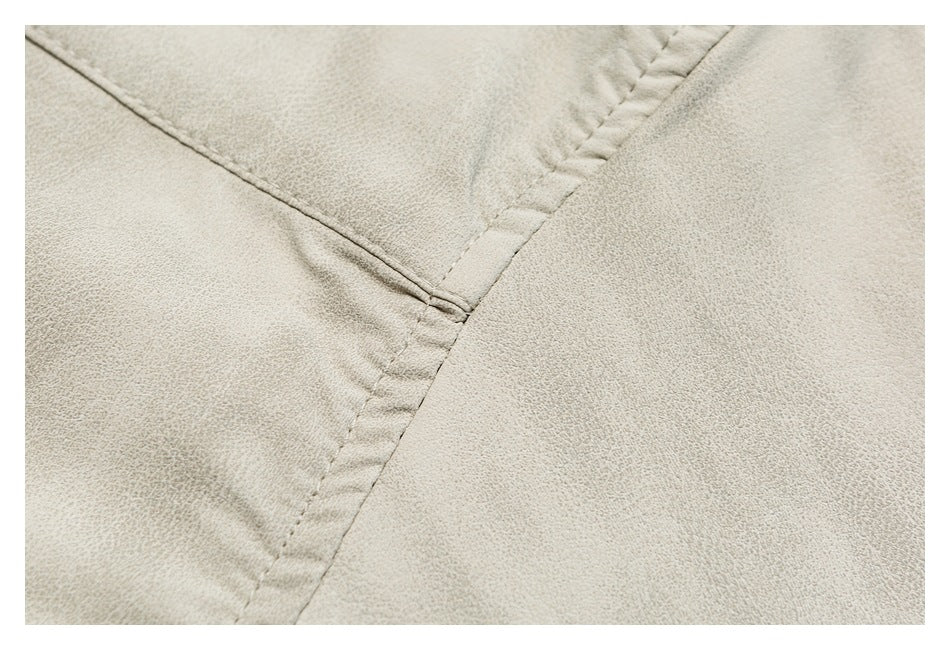 Close-up of light beige fabric showing a curved seam and stitching.