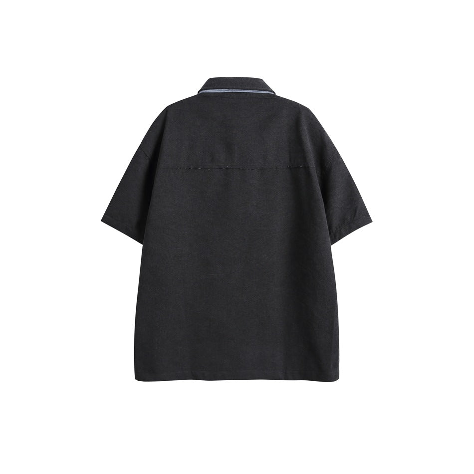 Back view of a plain black short-sleeve button-up shirt with a pointed collar and horizontal yoke seam.
