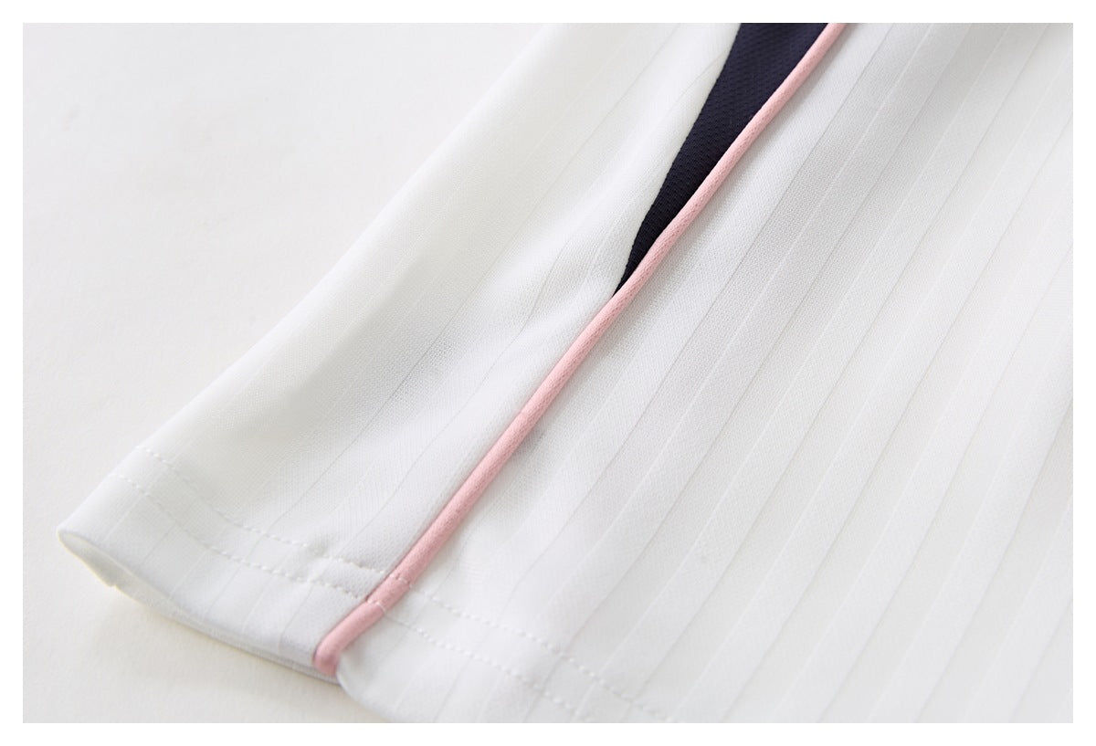 Close-up of white pleated fabric with pink piping beside a dark navy panel.
