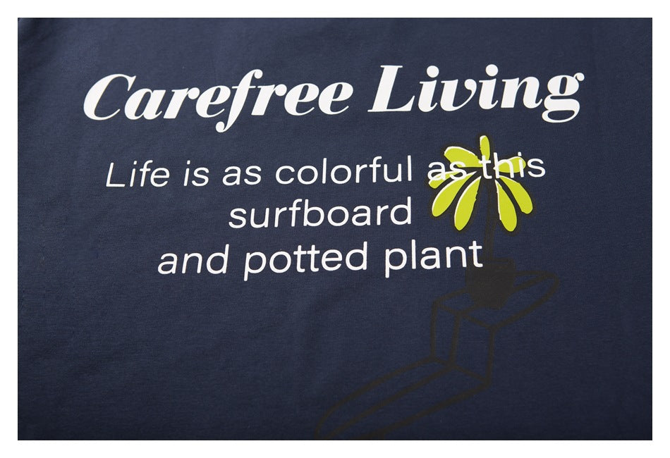 Close-up of the white and lime-green text and plant graphic printed on a navy T-shirt.