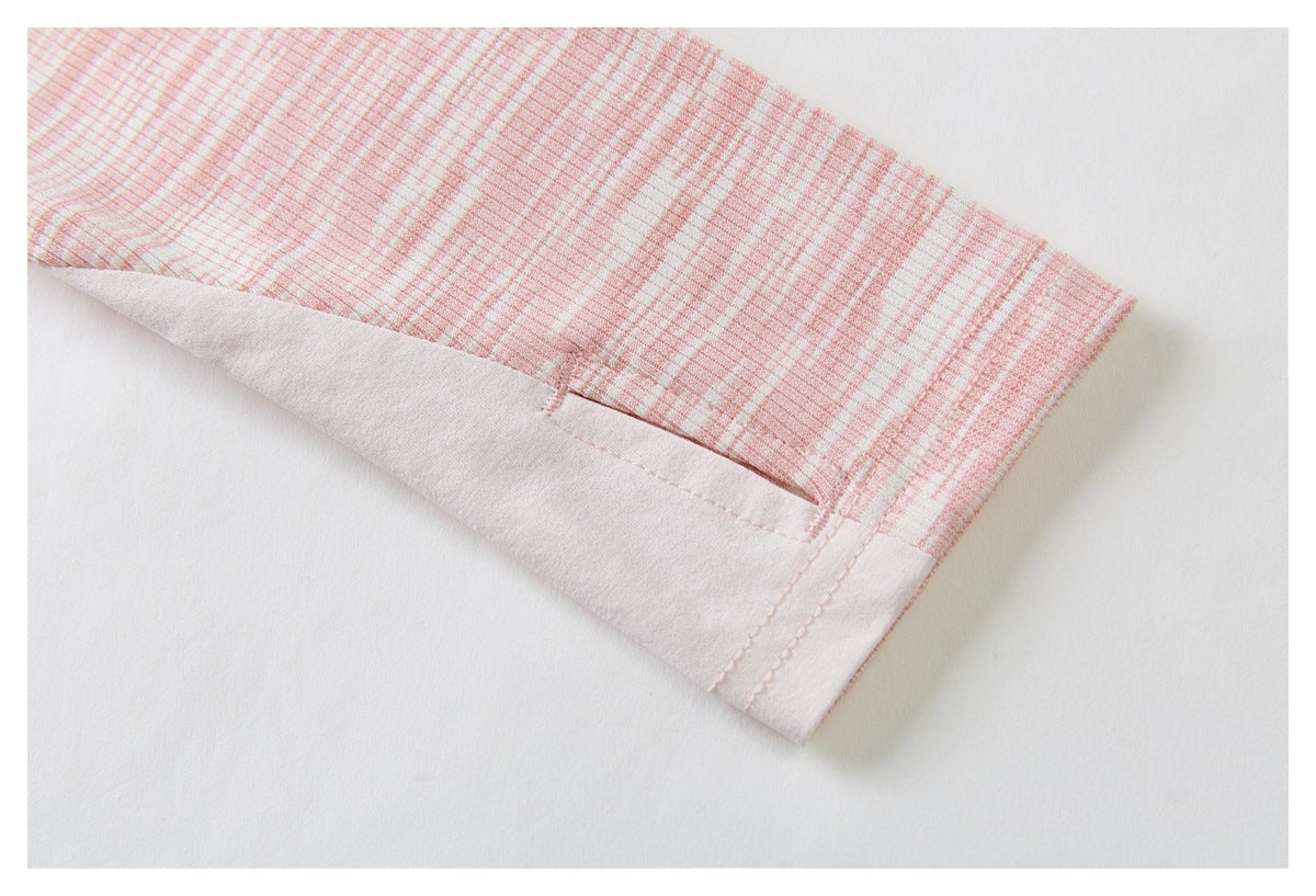 Close-up of the sleeve hem on a pink-and-white striped ribbed garment, showing the folded edge and stitching.
