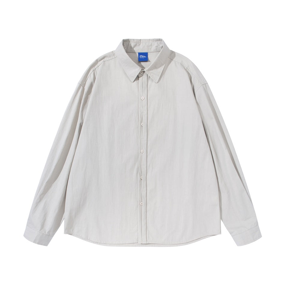 Light gray long-sleeve button-up shirt with pointed collar, front buttons and button cuffs, flat lay front view