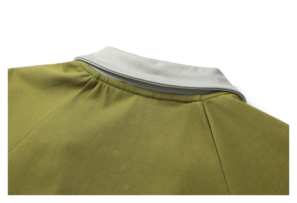Close-up of the shirt's back shoulder seams and light gray collar against olive-green fabric.